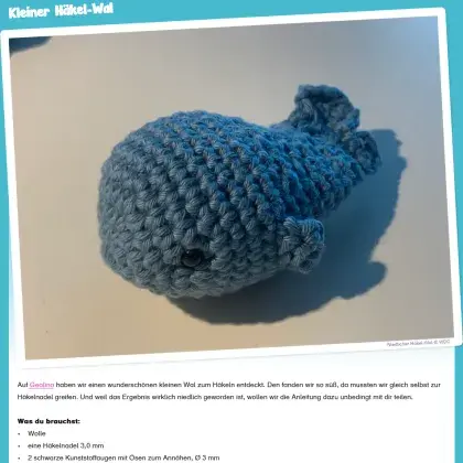 Man sieht einen kleinen gehäkelten Wal.